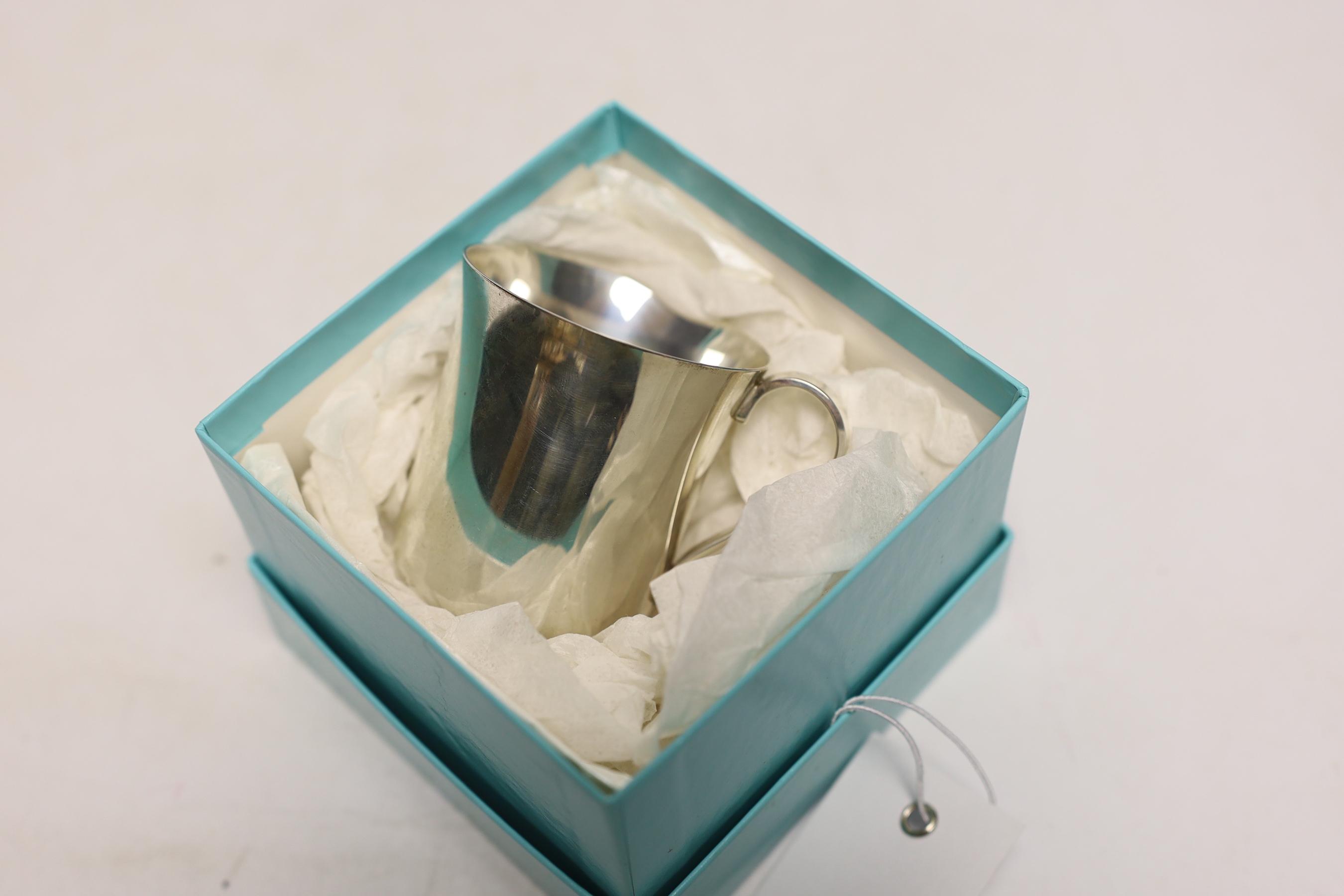 A modern Tiffany & Co sterling 925 christening mug, numbered 23245, height 6cm, 3.4oz, with Tiffany & Co box.